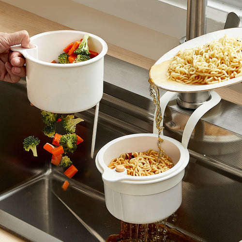 White hanging sink strainer basket on a kitchen faucet draining noodles